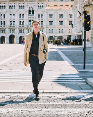 man with old vintage photocamera walking in trieste historic center