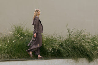 woman with brown blazer and large long trousers in technical fabric and loafers from ss26 new collection