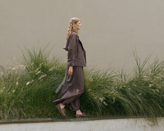 woman with brown set of technical trench jacket and large trousers