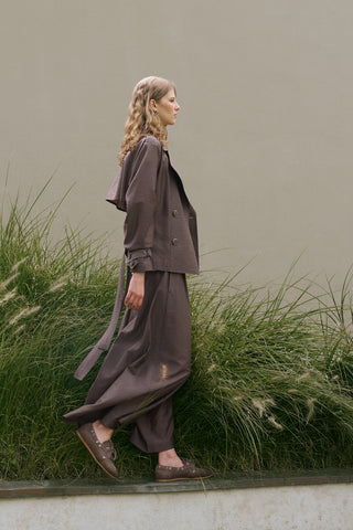 woman with brown blazer and large long trousers in technical fabric and loafers from ss26 new collection