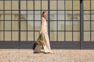 woman with beige Aurea linen top and trousers